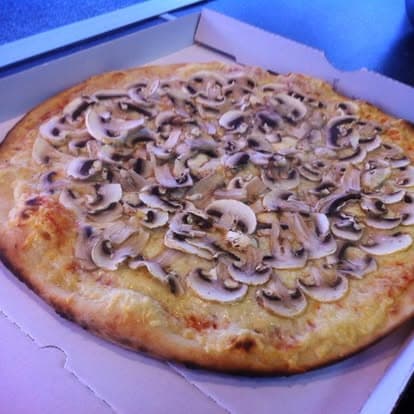 Une pizza aux champignons tout juste sortie du four